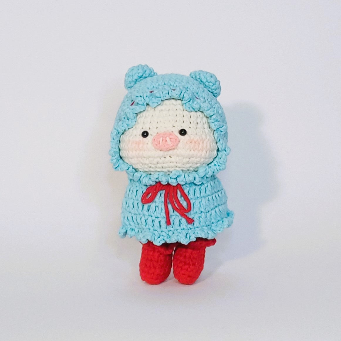 Handmade crochet of the adorable pig with a raincoat