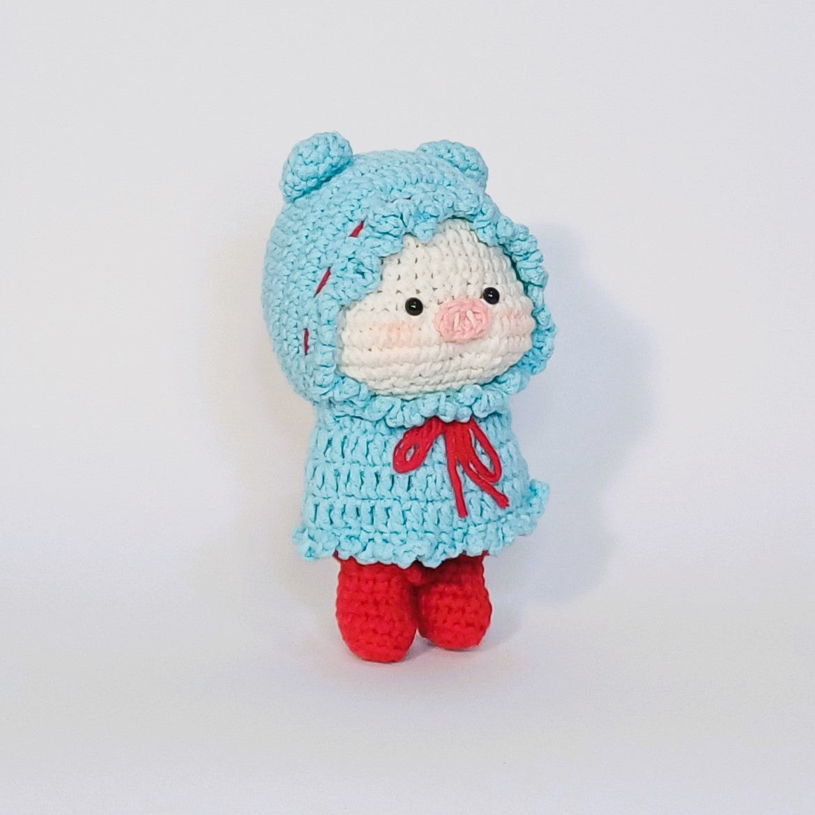 Handmade crochet of the adorable pig with a raincoat